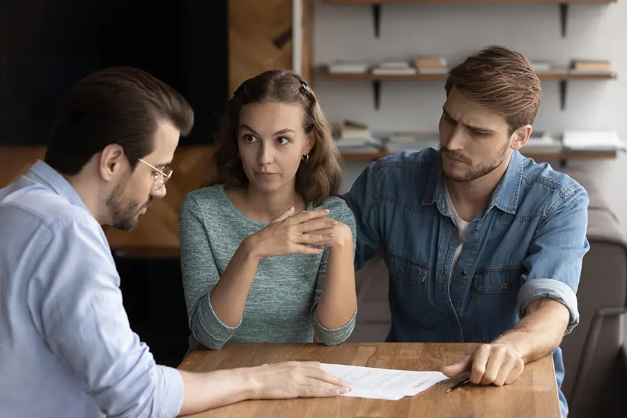 Inherited Las Vegas Property Couple consulting with a lawyer about inherited property options, discussing whether to rent or sell their house in Las Vegas, showcasing professional guidance for making informed decisions.