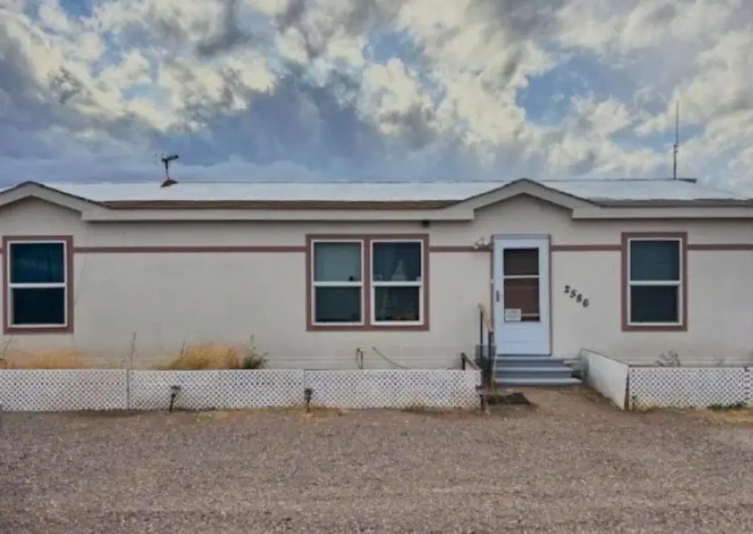 Selling a Home As Is in Nevada Exterior of an older home in Nevada listed for sale as-is, showing signs of minimal upkeep—perfect example of selling a home as is without repairs.